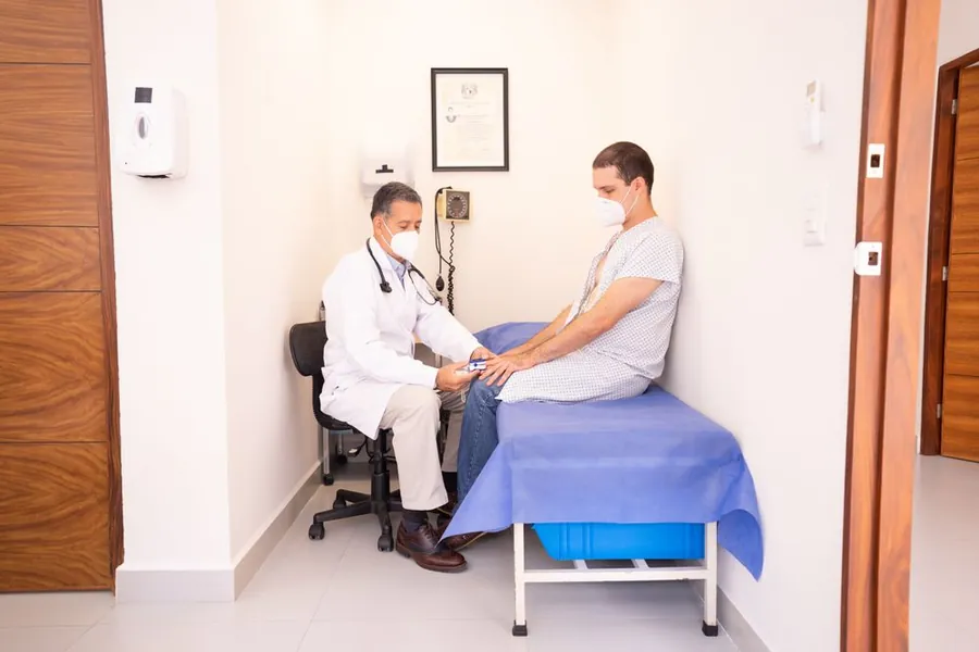 Clinician providing supervised medical care to a patient